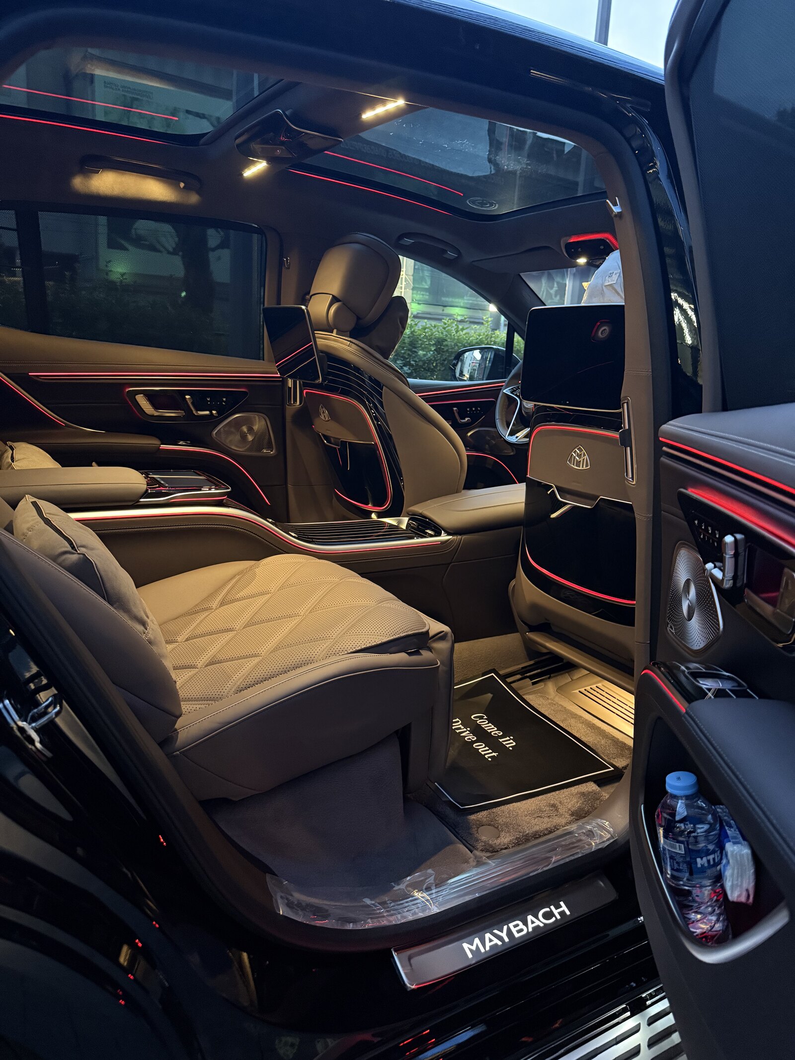 Maybach EQS rear cabin from the right door — the fixed centre console and the front cabin beyond