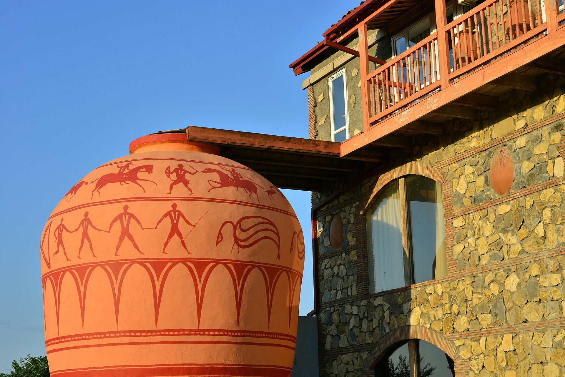 The Twins Old Cellar wine house in Kakheti, a stone-built traditional marani with rows of qvevri buried in the cellar floor.